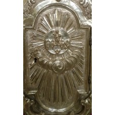 Baby Jesus on top of IHS and in the middle of sun symbol